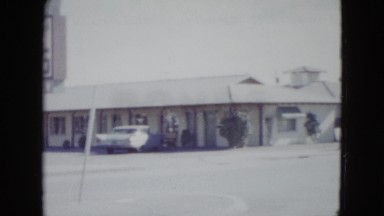 1958: the large esplanade of a large building with some vehicles parked NEVADA
