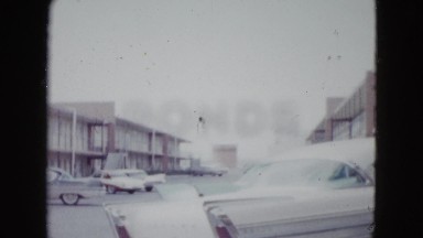 1958: a view of the grounds of an apartment complex with cars parked NEVADA