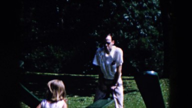 1955: man and girl at park playing on a seesaw and swings HICKSVILLE, NEW YORK