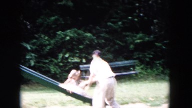 1955: a father and daughter at the playground slide on a sunny day HICKSVILLE