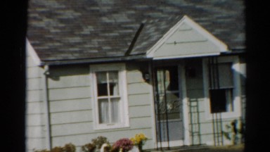 1964: a small cape-cod style home sitting in a residential area CALIFORNIA