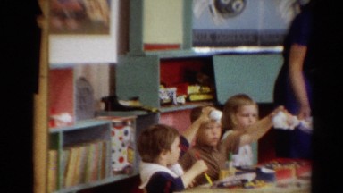 1964: a beautiful young school teacher passing out supplies to her children