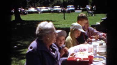 1964: mixed group enjoys meal at picnic table CALIFORNIA