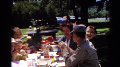 1964: people gathered outdoors at a table for a large family picnic CALIFORNIA