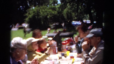 1964: people at the park having a picnic eating and talking