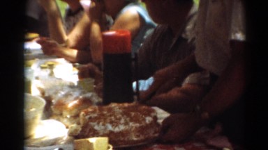 1964: man cutting cake at outdoor event CALIFORNIA