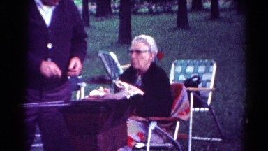 1964: old man having food hot in a lawn with trees around CALIFORNIA