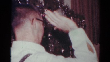 1964: opening presents under the christmas tree. CALIFORNIA
