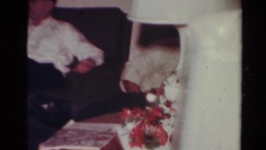 1964: family having a good time while unwrapping presents on holidays CALIFORNIA