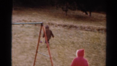 1964: kids running through the yard with baskets looking for easter eggs on the