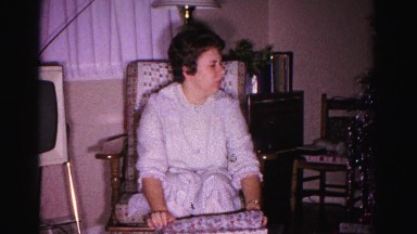 1967: a woman in a rocking chair unwrapping a christmas gift HAGERSTOWN