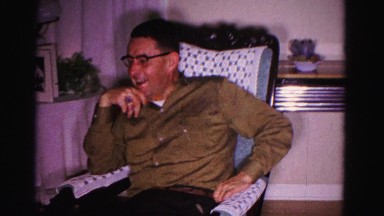 1967: man on a rocking chair and two people shoveling snow HAGERSTOWN, MARYLAND