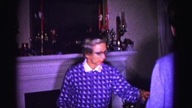 1967: an old woman and young couple are busy with something inside the room