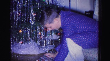 1967: a boy is busy with opening the present got for christmas day HAGERSTOWN