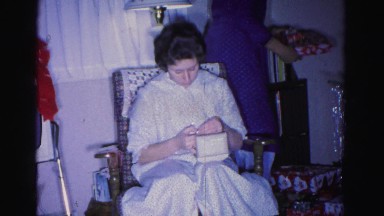 1967: woman receives new bracelet as a christmas gift and is excited to show it