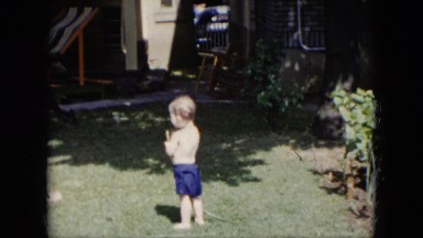 1951: Small Child Plays With Hose in Backyard Cleveland, Ohio