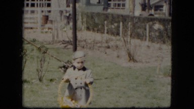 1951: Young Boy Carrying Easter Basket in Cleveland Ohio Neighborhood