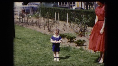 1951: kid walks down a grassy area family outing picnic mood CLEVELAND, OHIO