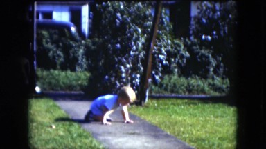 1951: a baby crawling and walking outdoor in the yard. CLEVELAND, OHIO