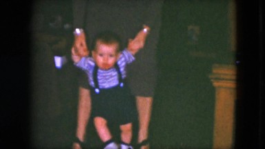 1951: mom is teaching a baby to walk CLEVELAND, OHIO