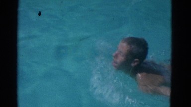 1953: blond boy swims in pool NEW YORK