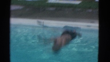 1953: a boy is competing in swimming in the pool NEW YORK