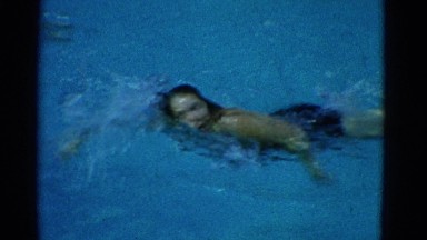 1953: a young lady swimming in a crystal clean swimming pool NEW YORK