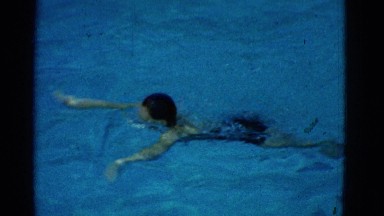 1953: a young woman is swimming in the pool NEW YORK