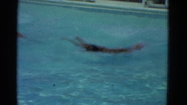 1953: Kid Swimming Freestyle in Pool with Water Waves in New York
