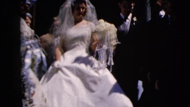 1962: a bridal couple leaves the ceremony and are greeted by attendants