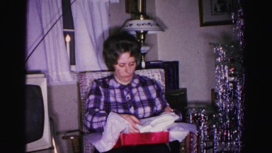 1967: mother beside christmas tree packing gift HAGERSTOWN, MARYLAND