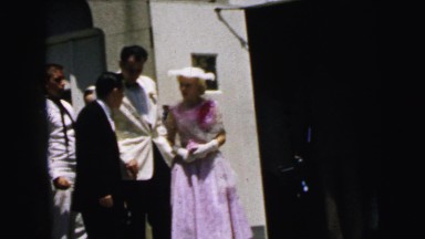 1964: young couple in formal wear receiving instructions from a man CAMDEN