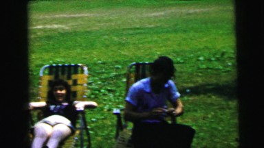 1964: men and women relax in lounge chairs as a horse stands in the background