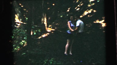 1964: a young couple walking and frolicking happily in a wooded area CAMDEN
