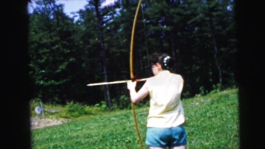 1964: garden scene, girl practising archery