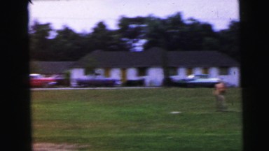 1964: young people are playing baseball in a field near a mountain summer camp