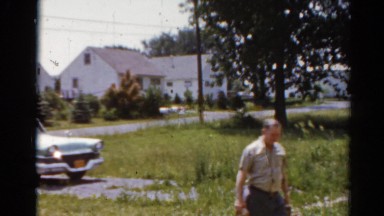 1964: a woman carrying a bag of groceries in from the car CALIFORNIA