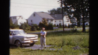 1964: family walking children exiting station wagon parked on gravel driveway