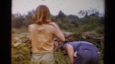 1964: three boys and a girl are picking wildflowers randomly by a wilderness
