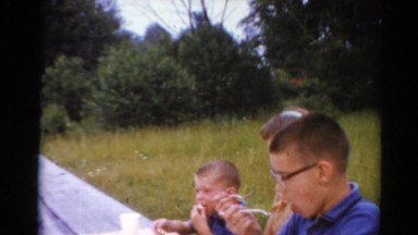 1964: three beautiful children eating sweets on the roadside CALIFORNIA