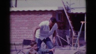 1968: a father playing with his two sons outdoor CLARKSDALE, ARIZONA