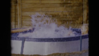 1968: two children playing splashing strongly on a portable pool CLARKSDALE