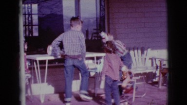 1968: three kids playing on the veranda with headlights CLARKSDALE, ARIZONA
