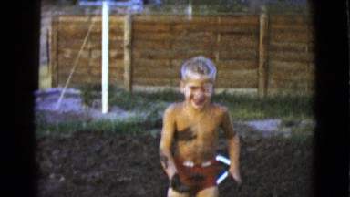 1968: two boys playing in a yard throwing mud each other CLARKSDALE, ARIZONA