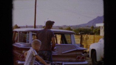 1968: a boy watching his father pack the car CLARKSDALE, ARIZONA