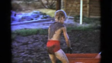 1968: cute young boys outdoor in the yard playing with the mud CLARKSDALE