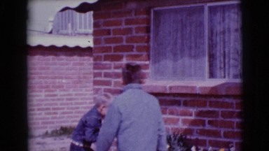 1968: two kids searching for easter eggs outdoor of their house CLARKSDALE