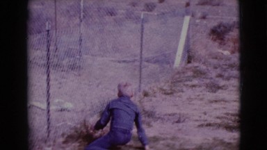1968: children play desert fenced walk down danger CLARKSDALE, ARIZONA
