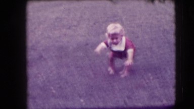1942: little blonde girl eating and playing outdoor. NEW YORK