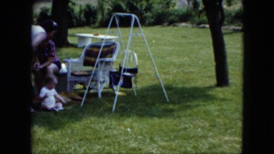1951: a few people enjoying a lovely day in their yard with their family